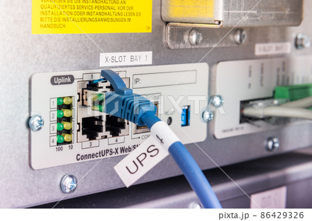 Back side of a server with ethernet cable connected in the slot Back side of a server with ethernet cable connected in the slot 86429326