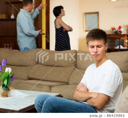 Spouses quarrelling while their son sitting Spouses quarrelling while their son sitting 86429963