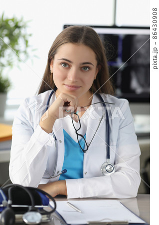 Portrait of woman doctor with glasses in her hands in clinic office 86430908