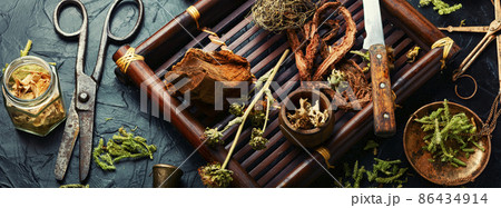 Tray with healing herbs. 86434914