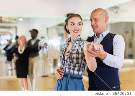 Man and woman performing ballroom dance in dancing room 86436251