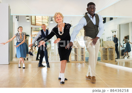 Senior womaSenior woman dancing swing in studion and man dancing swing in studio Senior womaSenior woman dancing swing in studion and man dancing swing in studio 86436258