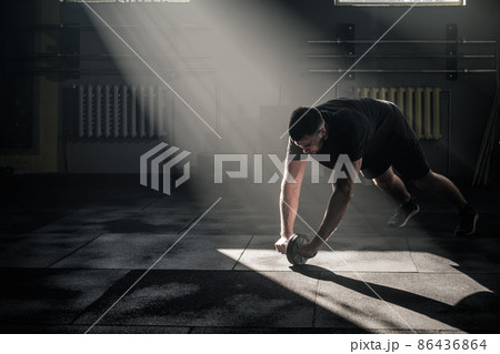 Focused Male Train Arms Muscles in Gym Club . 86436864