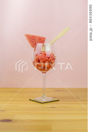 Sliced watermelon in a glass with a spoon Sliced watermelon in a glass with a spoon 86436990