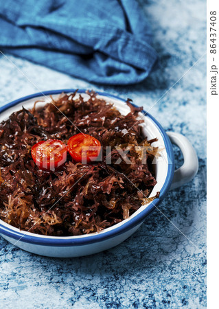white enamel saucepan with some cooked irish moss 86437408