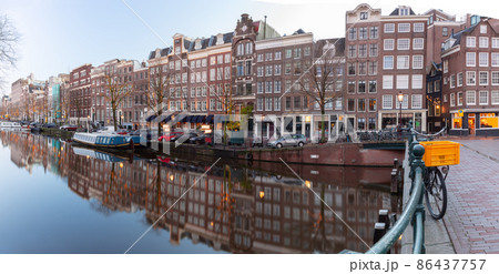 Panorama of the city embankment of Amsterdam at dawn. 86437757