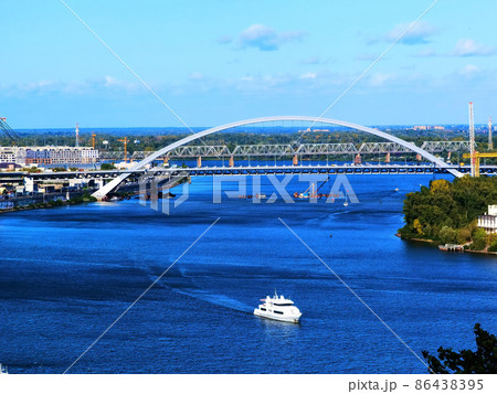 Aerial top view of Kyiv cityscape, Dnieper river and Podol historical district skyline from above, Kontraktova square with ferris wheel, city of Kiev, Ukraine. Aerial top view of Kyiv cityscape, Dnieper river and Podol historical district skyline from above, Kontraktova square with ferris wheel, city of Kiev, Ukraine. 86438395