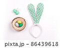 Colorful decorations with Easter egg nest and rabbit ears on white background. copy space, top view 86439618