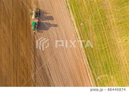 Tractor Ploughing Field Aerial View Tractor Ploughing Field Aerial View 86440874