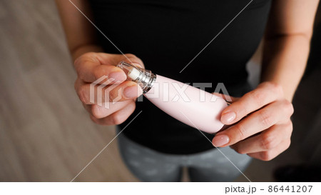 Vacuum blackhead remover in woman hand, cosmetic beauty procedure at home 86441207