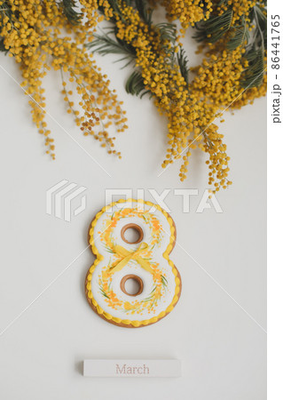 Women's Day, March 8, figure eight, gingerbread, flowers. Space for text. 86441765