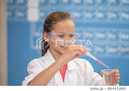 Smiling girl with pipette and test tube 86441860