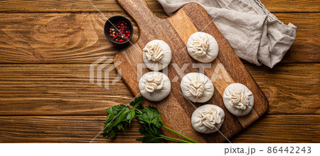 Raw freshly made Khinkali, traditional dish of Georgian Caucasian cuisine, dumplings 86442243