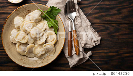Pelmeni, traditional dish of Russian cuisine, boiled dumplings with minced meat Pelmeni, traditional dish of Russian cuisine, boiled dumplings with minced meat 86442256