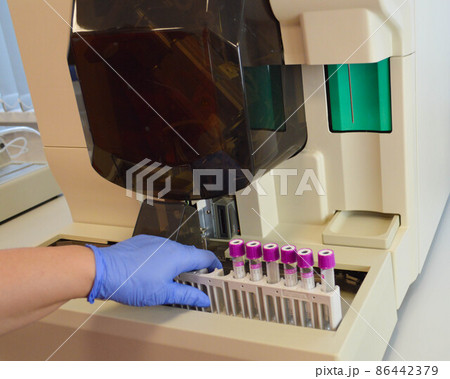 Researcher, doctor, scientist or laboratory assistant working with plastic medical tubes in modern lab or hospital Researcher, doctor, scientist or laboratory assistant working with plastic medical tubes in modern lab or hospital 86442379