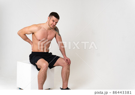 A man back pain keeps his hand on his back pain hurt painful, backache person man health medicine, muscular lumbar care, ain suffer attractive A man back pain keeps his hand on his back pain hurt painful, backache person man health medicine, muscular lumbar care, ain suffer attractive 86443381