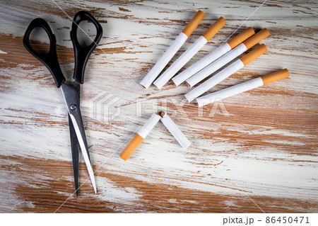 Scissors cut a cigarettes. Addiction, health... - Stock Photo [86450471]