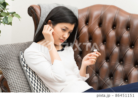 イヤホンの長時間使用で耳に違和感を感じる女性　イヤフォン外耳炎 86451151