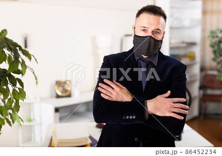 Business in mask standing in his office Business in mask standing in his office 86452234