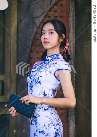 Asian woman in traditional Chinese dress or Qipao Asian woman in traditional Chinese dress or Qipao 86454932