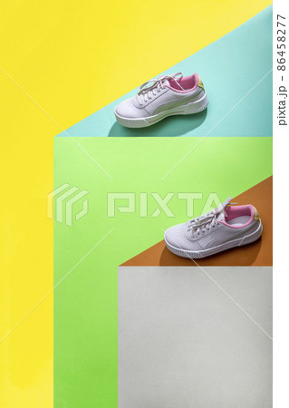 Geometric still life with sports sneakers on a colored background Geometric still life with sports sneakers on a colored background 86458277