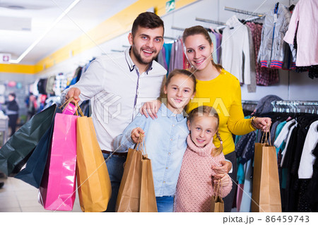 family of four with shopping bags 86459743