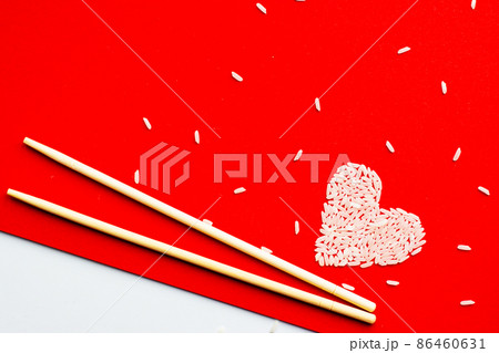 Heart made from rice on a red background. Sushi sticks Heart made from rice on a red background. Sushi sticks 86460631