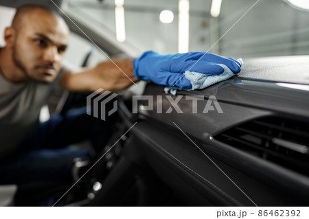 A man cleaning car interior, car detailing in Carwash service 86462392