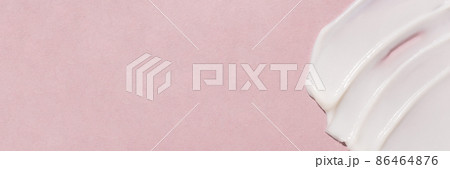 Smear of cosmetic cream on a pink background. Smear of cosmetic cream on a pink background. 86464876