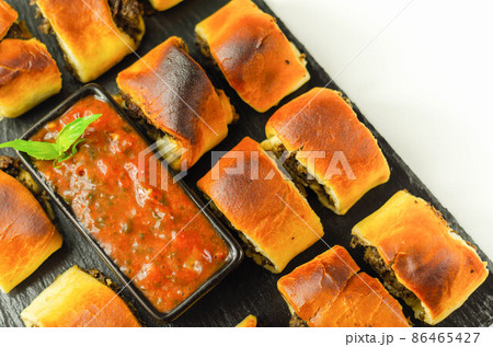Patty's pies stuffed with minced meat, mushrooms and onion, served with sauce Patty's pies stuffed with minced meat, mushrooms and onion, served with sauce 86465427