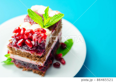 Colorful multi-layered cream chocolate cake with cherry jam and pomegranate Colorful multi-layered cream chocolate cake with cherry jam and pomegranate 86465521