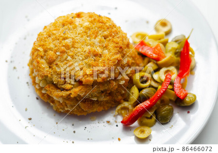 Cod and prawns red Thai style fish cake served with pickled olives, gherkin, garlic, and red peppers 86466072