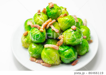 Tasty brussels sprouts with smoked bacon lardons and salted butter Tasty brussels sprouts with smoked bacon lardons and salted butter 86466119