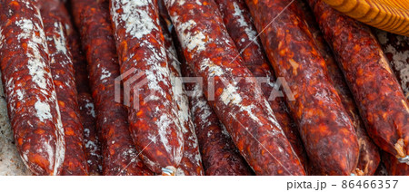 Typical Spanish sausages lying on a village stall at the food market 86466357