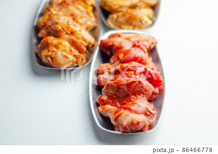 Three different set of the chicken wings with sriracha glaze, Caribbean marinade and Chinese glaze 86466778