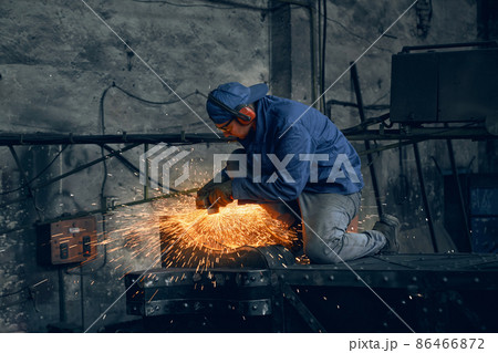 Qualified welder working with metal frame indoors Qualified welder working with metal frame indoors 86466872