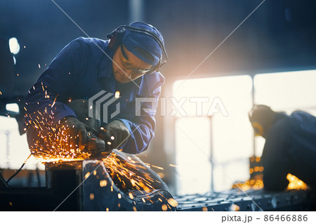 Caucasian man welding metal construction on factory 86466886