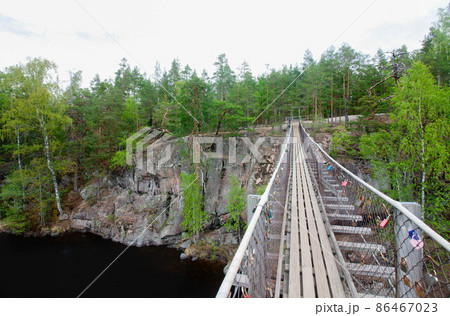 Rope bridge in the National Park Repovesi, Finland. 86467023