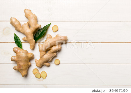 Finely dry Ginger powder in bowl with green leaves isolated on colored background. top view flat lay 86467190