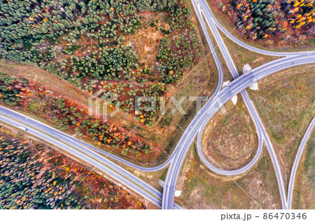 Aerial of highway road through autumn forest Aerial of highway road through autumn forest 86470346