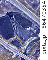 Aerial view on a frozen lake between countryside road highway in winter 86470354