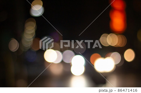 Out of focus defocused blurred bokeh of cars and traffic lights at night on city street. 86471416