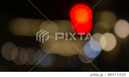 Out of focus defocused blurred bokeh of cars and traffic lights at night on city street. Out of focus defocused blurred bokeh of cars and traffic lights at night on city street. 86471420