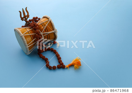 Shivaratri background with Shivas trident and Pellet Drum Damroo musical instrument . Hindu festival Maha Shivratri Shivaratri background with Shivas trident and Pellet Drum Damroo musical instrument . Hindu festival Maha Shivratri 86471968