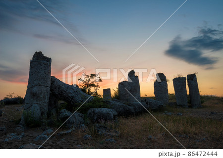 Beautyful sunrise over The Stone Desert Pobiti Kamani - fabulous rock phenomenon in Varna Province, Bulgaria - tourist destination Beautyful sunrise over The Stone Desert Pobiti Kamani - fabulous rock phenomenon in Varna Province, Bulgaria - tourist destination 86472444