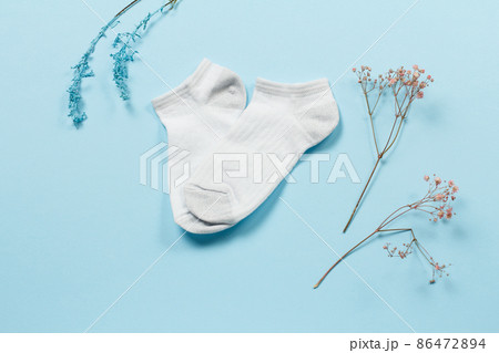 Pair of women socks on blue background. 86472894