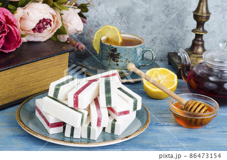 Composition on table with marshmallows, cup of tea. Composition on table with marshmallows, cup of tea. 86473154