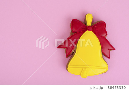 Homemade gingerbread with icing in shape of bells. 86473330