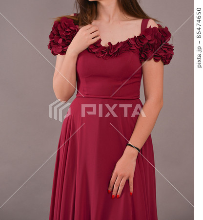 woman wearing a red long dress is having a studio photo shooting woman wearing a red long dress is having a studio photo shooting 86474650