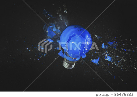 blue light bulb exploding on black. blue light bulb exploding on black. 86476832